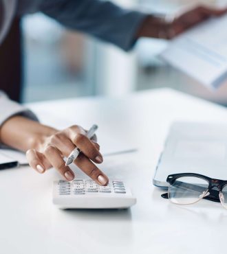 cropped-shot-of-a-businesswoman-using-a-calculator-2022-10-04-23-43-52-utc (1)-01